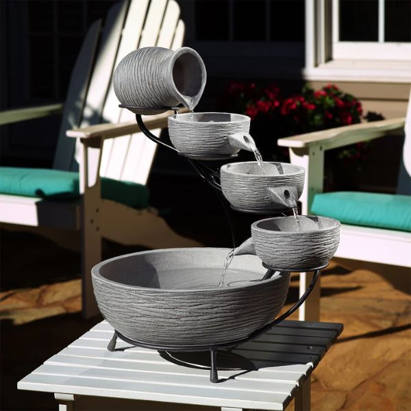 Outdoor fountain with gray bowls on a table