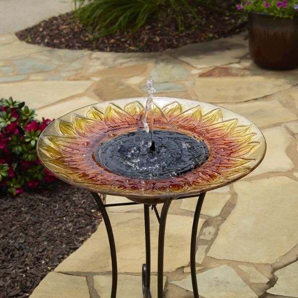 Sunflower-shaped solar water fountain on a stone patio