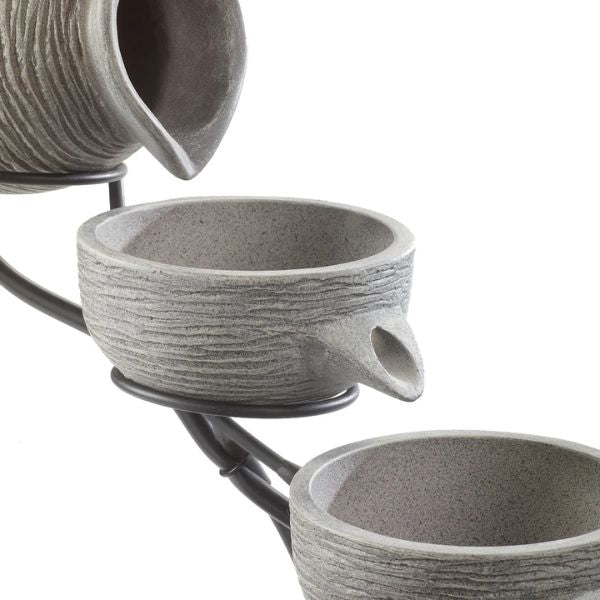 Set of three gray stone-textured ceramic cups on a white background