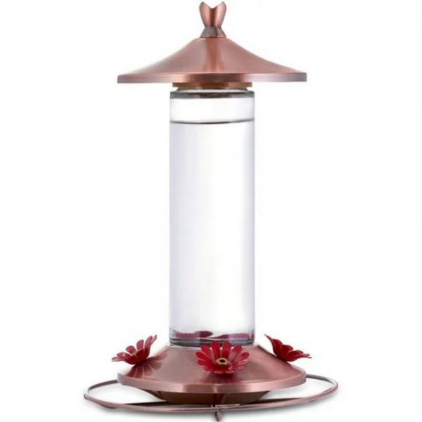 Copper and clear hummingbird feeder with red flowers on a white background