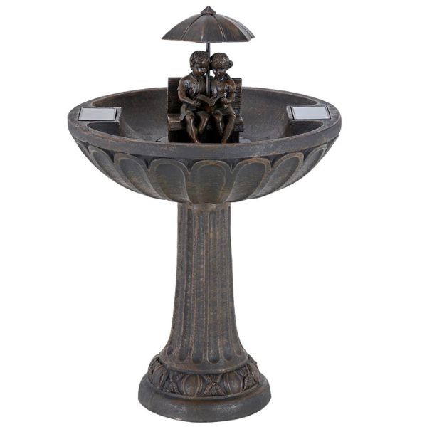 Decorative outdoor fountain with statues under an umbrella on a white background