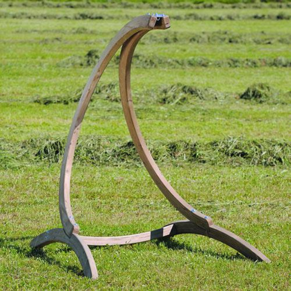 Wooden stand with curved design on a grassy field