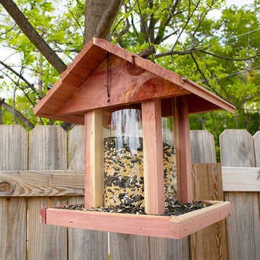 Eco-friendly Amish Made Cedar Hopper Feeder with a seed cylinder, ideal for backyard birdwatching and feeding
