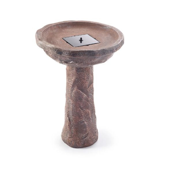 Stone-like bird bath with a metallic drain cover on a white background