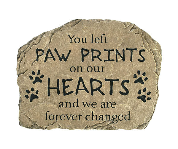 Decorative stone with text 'You left paw prints on our hearts and we are forever changed' on a white background