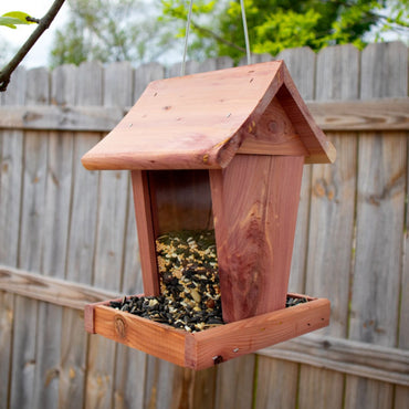 Handmade Amish Cedar and Recycled Plastic Hopper Bird Feeder with a red roof, built for durability and eco-friendly bird feeding