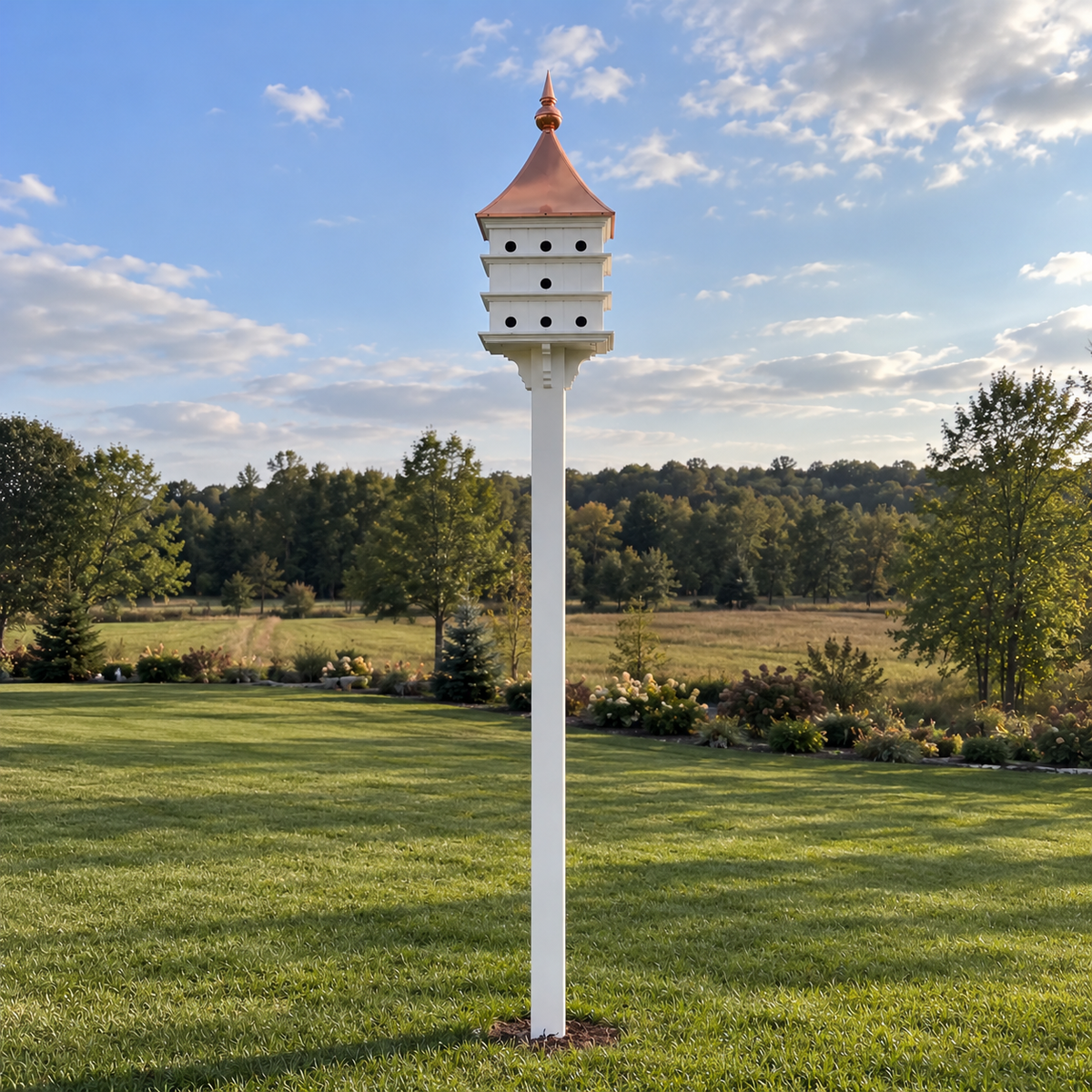 installed copper roof purple martin house mounted on a 10' vinyl sleeve in an open backyard