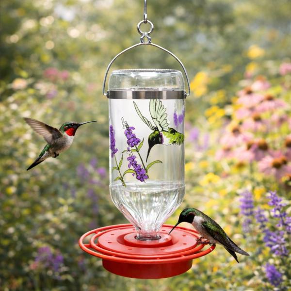 Triple orb hummingbird feeder with hummingbirds flying around the feeder.  Green blurred background