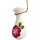White ceramic vase with floral design on a white background