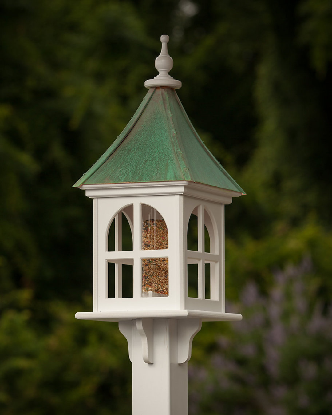 Handcrafted Copper Roof Bird Feeder with Arch Window, made from durable cellular PVC. Features a lift-off roof, 4x9 acrylic tube, and decorative brackets. Maintenance-free with no rotting, cracking, or fading. USA-made, fits 4x4 post. Bright or Patina Copper Roof options. Free shipping!
