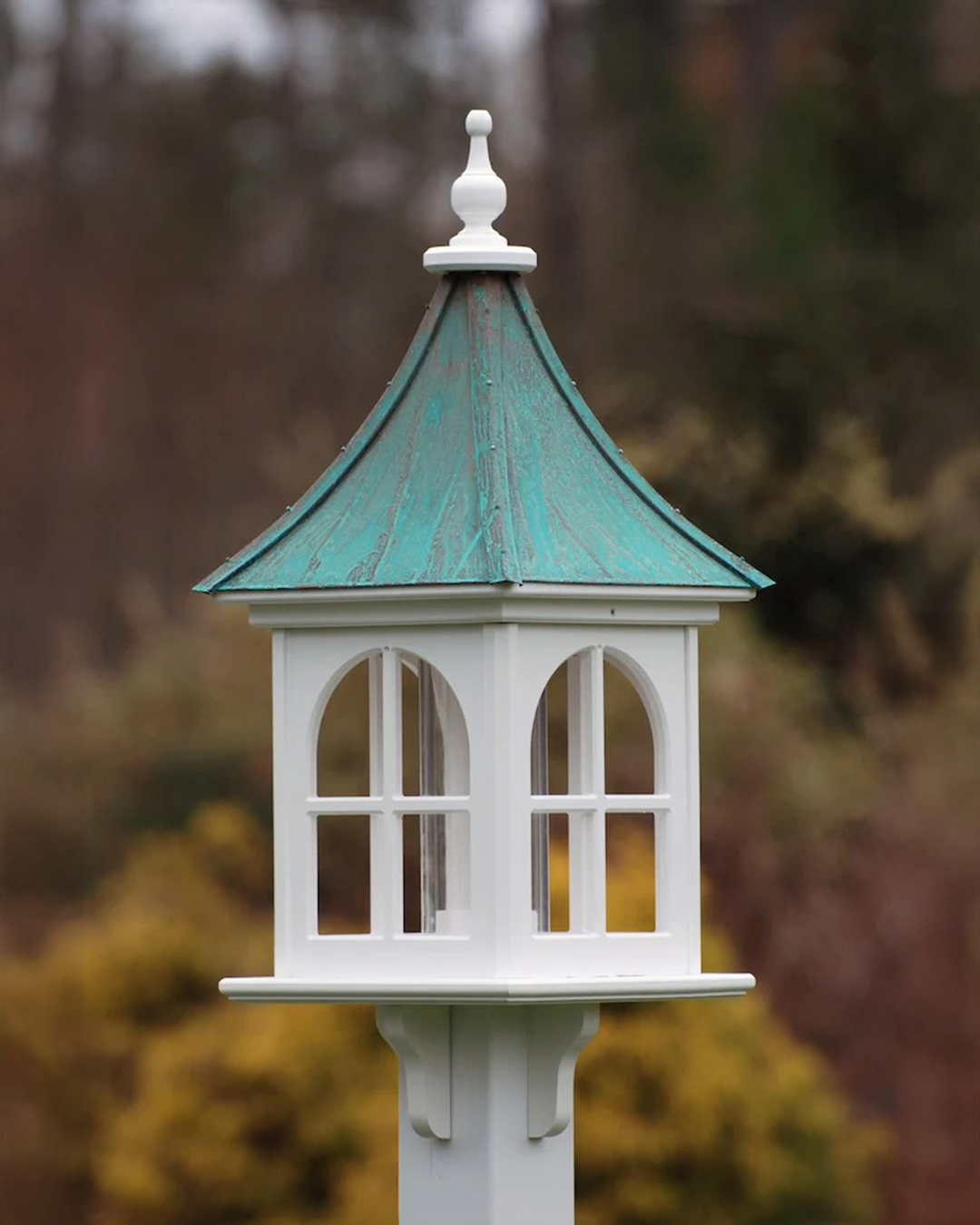 Handcrafted Copper Roof Bird Feeder with Arch Window, made from durable cellular PVC. Features a lift-off roof, 4x9 acrylic tube, and decorative brackets. Maintenance-free with no rotting, cracking, or fading. USA-made, fits 4x4 post. Bright or Patina Copper Roof options. Free shipping!