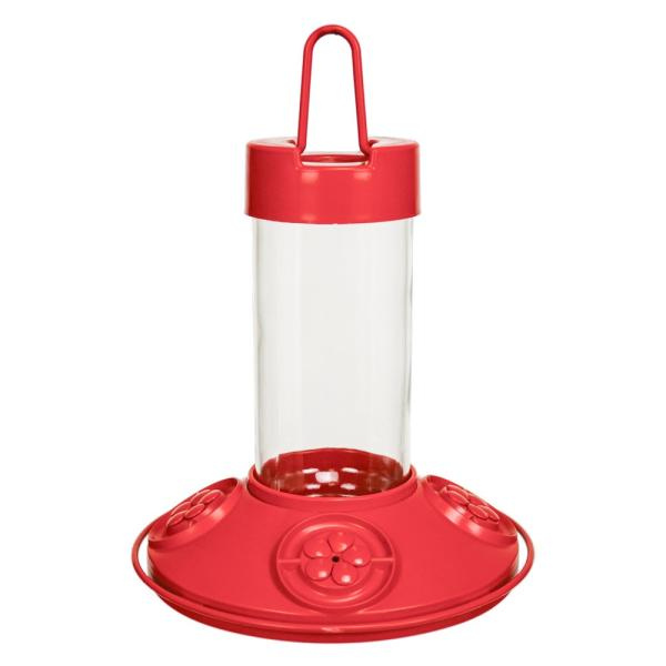 Red and clear plastic hummingbird feeder on a white background