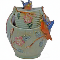 Decorative ceramic vase with floral and bird designs on a white background