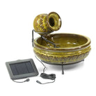 Decorative ceramic water fountain with solar panel on a white background