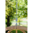 Wooden swing with metal chain and spring against a blurred green outdoor background