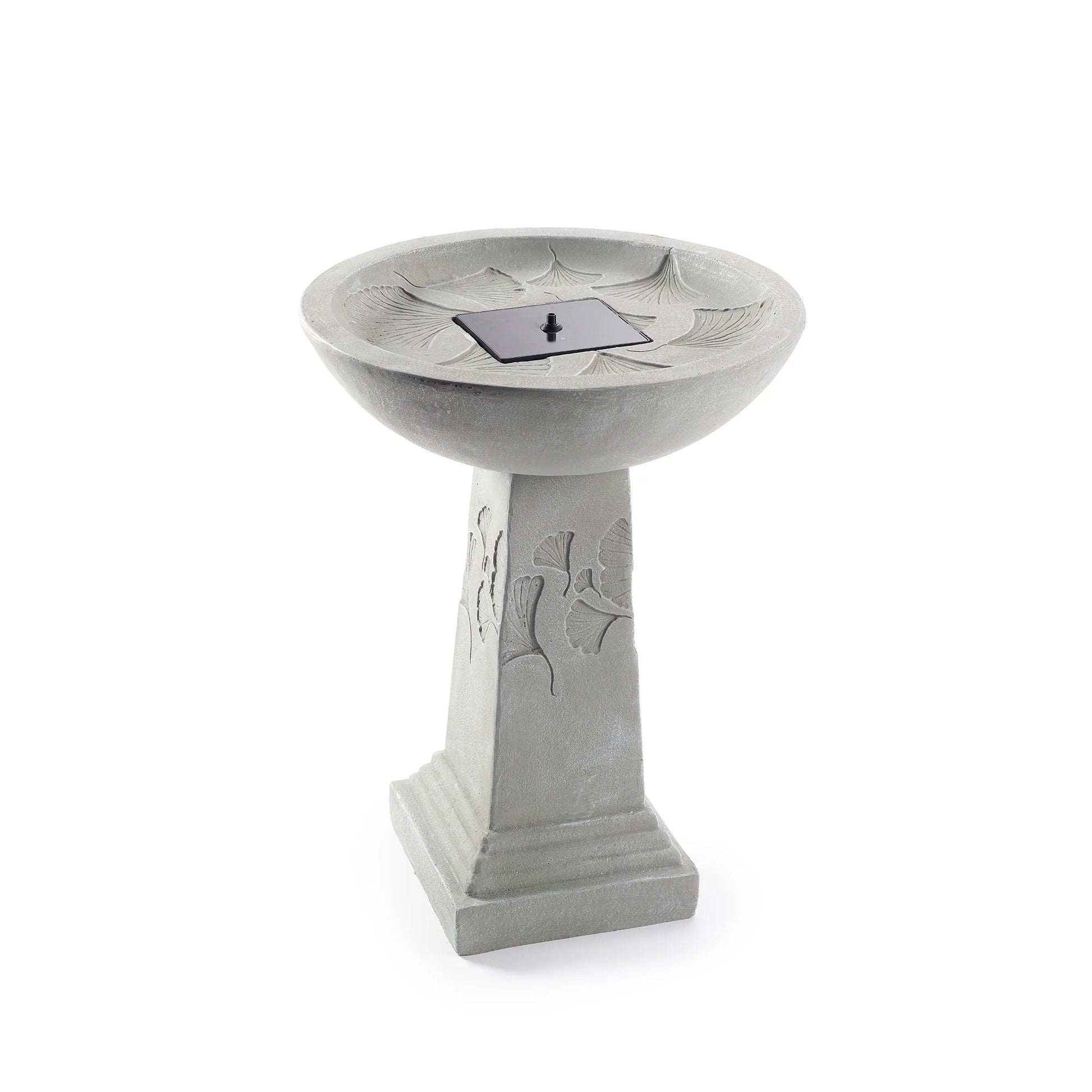 Ginko Tall Solar Bird Bath with a weathered stone finish, featuring ginkgo leaf patterns on the pedestal and a black solar panel centered in the shallow bowl.
