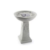 Ginko Tall Solar Bird Bath with a weathered stone finish, featuring ginkgo leaf patterns on the pedestal and a black solar panel centered in the shallow bowl.