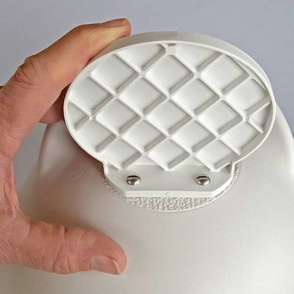 Hand holding a white textured light fixture against a plain background