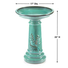 Turquoise bird bath with decorative design and dimensions on a white background