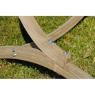 Wooden garden tool with bristles on a grassy background