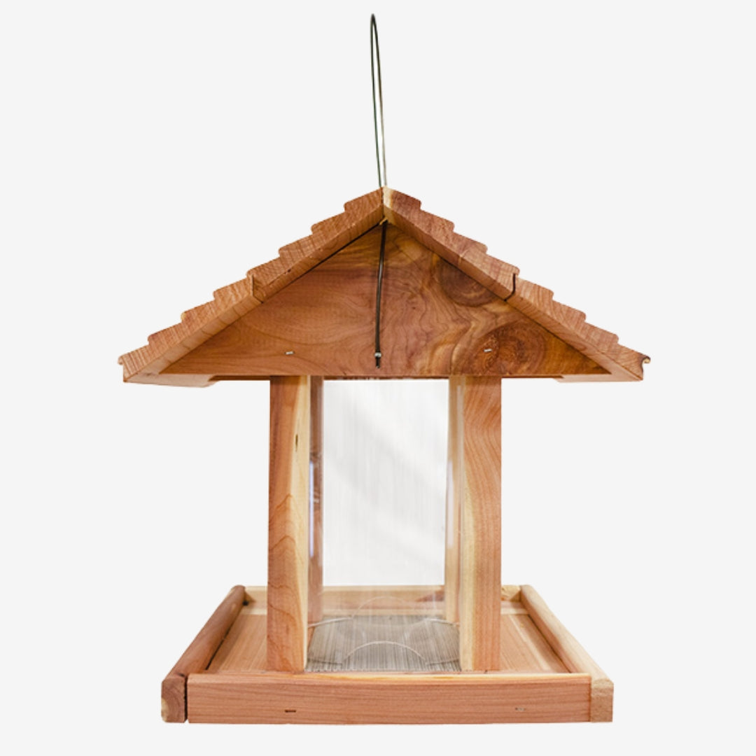 Eco-friendly Amish Made Cedar Hopper Feeder with a seed cylinder, ideal for backyard birdwatching and feeding