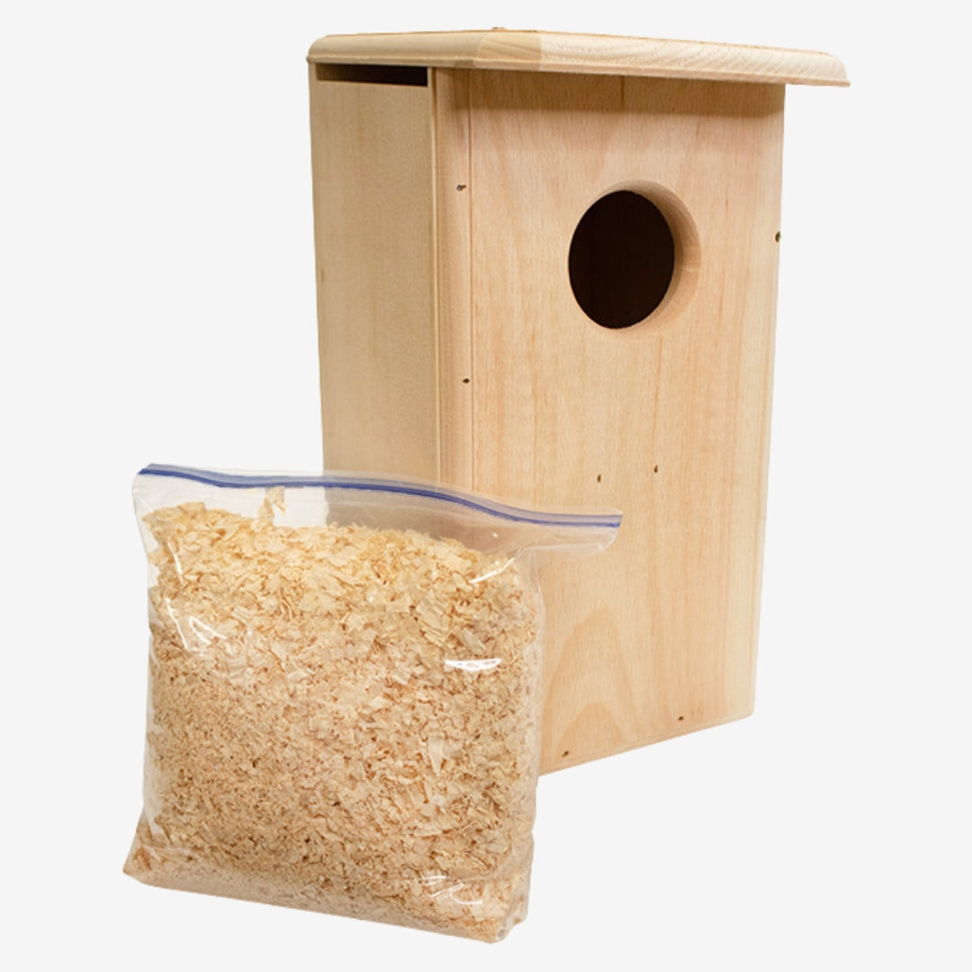 Coveside premium nesting box on a tree, crafted from durable cedar to attract screech owls and kestrels, providing a secure and weatherproof wildlife shelter.