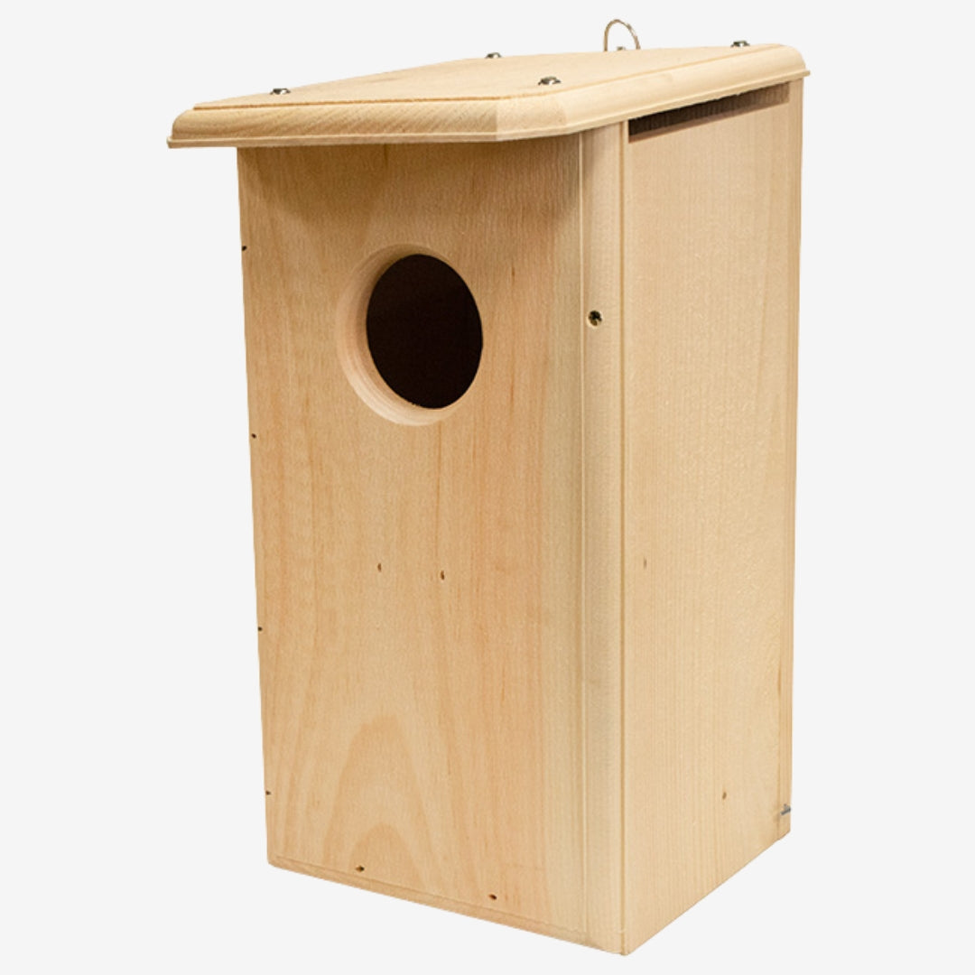 Coveside premium nesting box on a tree, crafted from durable cedar to attract screech owls and kestrels, providing a secure and weatherproof wildlife shelter.