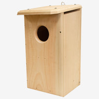 Coveside premium nesting box on a tree, crafted from durable cedar to attract screech owls and kestrels, providing a secure and weatherproof wildlife shelter.