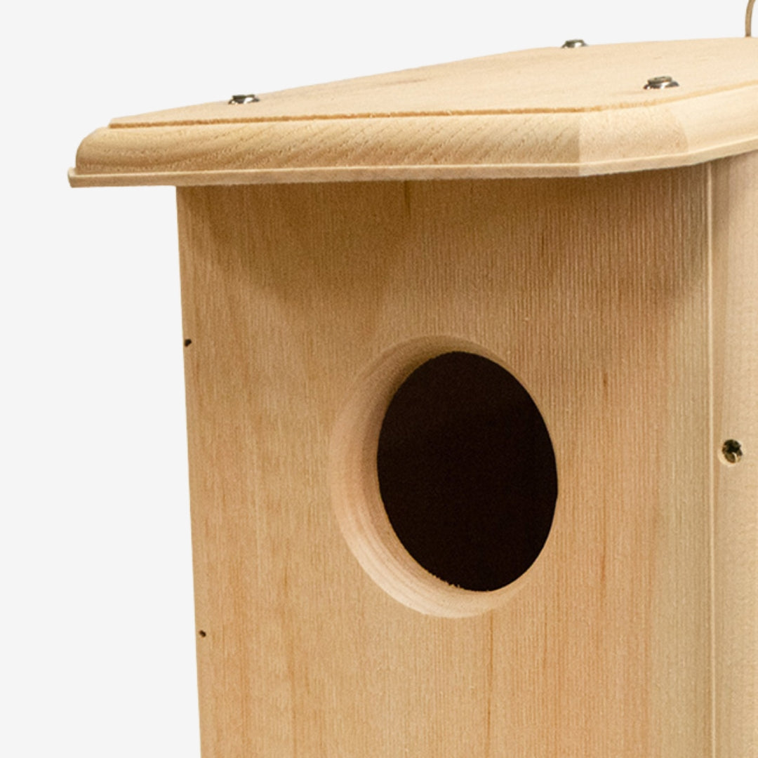 Coveside premium nesting box on a tree, crafted from durable cedar to attract screech owls and kestrels, providing a secure and weatherproof wildlife shelter.