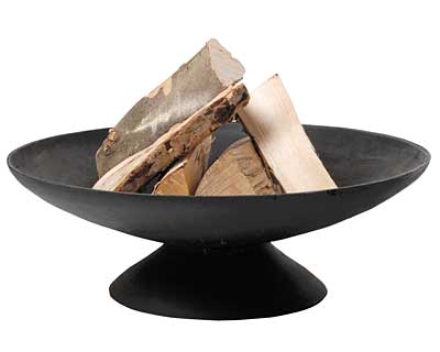 A black, wide, shallow fire bowl with a central pedestal base contains several large pieces of chopped wooden logs, set against a plain white background.