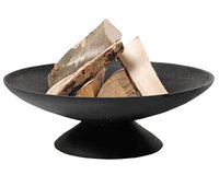 A black, wide, shallow fire bowl with a central pedestal base contains several large pieces of chopped wooden logs, set against a plain white background.