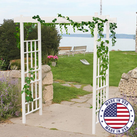 The Classic Garden Arbor featuring rectangular grid panels with climbing ivy, providing support and adding a fresh, green touch to a pathway.