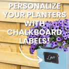 A ColorPop Garden Wall Planter in blue, featuring purple flowers and a chalkboard label that can be personalized with names or messages.