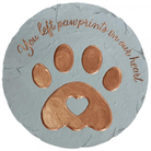 Memorial stone with copper paw prints and text on a white background