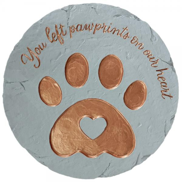 Memorial stone with copper paw prints and text on a white background