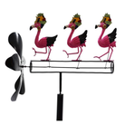 Decorative windmill with pink flamingo figures on a white background