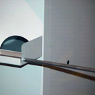Metal towel rack mounted on a wall with a blurred background