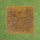 Close-up of Golden Wing Dragonfly Stepping Stone with raised dragonfly design and textured surface.