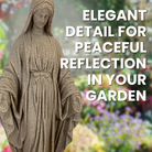 lose-up of the Mother Mary Garden Statue showing intricate detailing on her robes, face, and the serene expression of faith. The statue also displays the symbolic serpent and apple at the base.