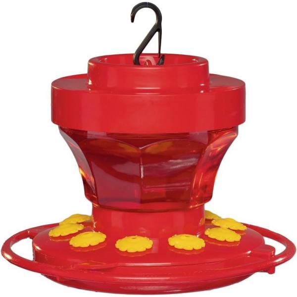 Red and yellow hummingbird feeder with a hook on a white background
