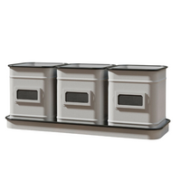 Three planters placed inside a matching metal tray with a vintage white enamel finish and black accents.