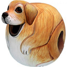 A round, hand-carved wooden dog sculpture with a smiling face. The dog is painted in shades of tan and white, exuding a whimsical and playful tone.