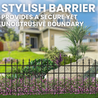 A garden with colorful flowers behind a decorative finial-topped fence, creating an elegant boundary around the garden.