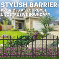 A garden with colorful flowers behind a decorative finial-topped fence, creating an elegant boundary around the garden.