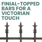 A fully installed garden fence with finial-topped bars, creating a stylish yet secure boundary for the garden.