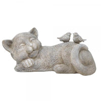 Statue of a cat lying down with two birds on its back against a white background
