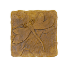 Close-up view of the Golden Wing Dragonfly Stepping Stone, highlighting the intricate raised design of a dragonfly with textured golden-brown concrete, adding charm and stability to your garden.