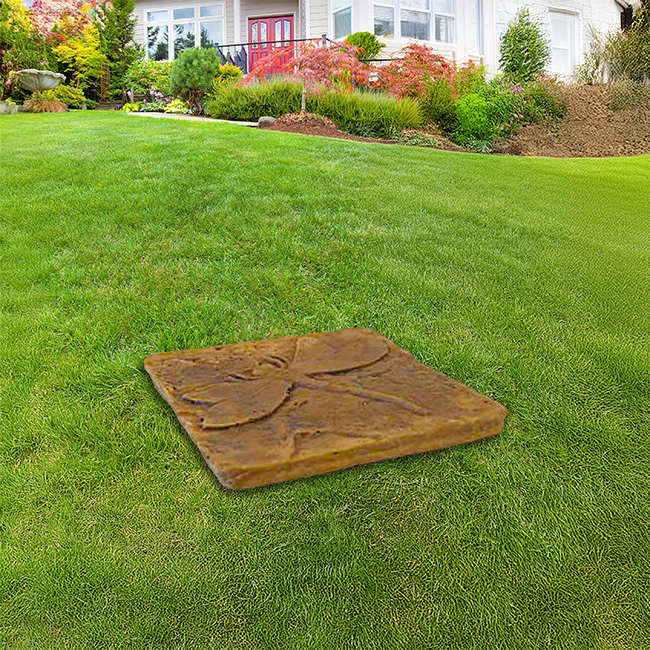 Golden Wing Dragonfly Stepping Stone placed on a garden lawn path for decoration.


