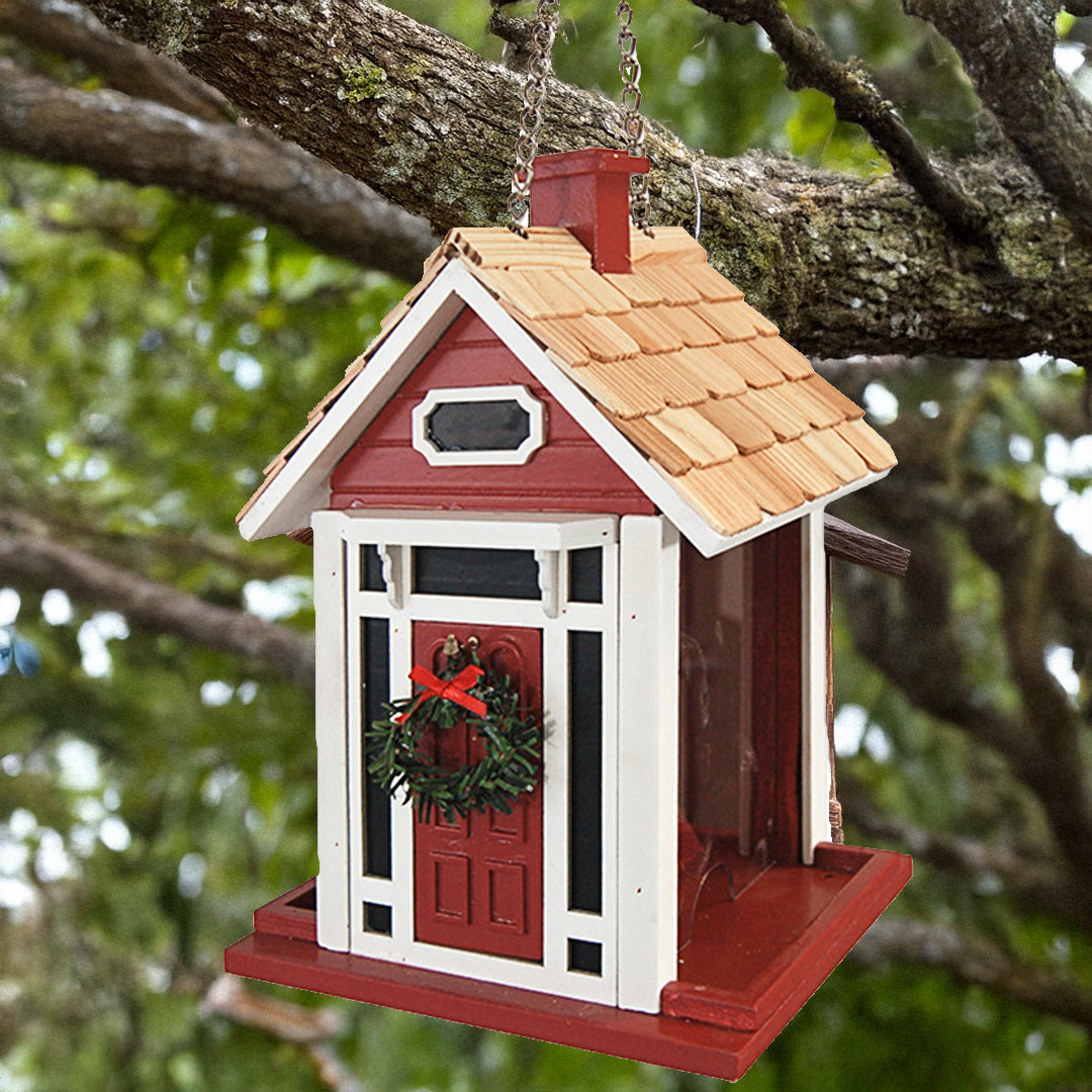 Red Christmas cottage bird feeder by Home Bazaar, designed to attract birds while adding festive charm to your garden.