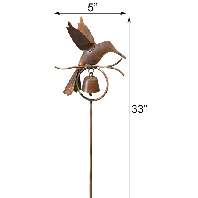 The Hummingbird Bell Garden Stake, beautifully detailed with a flamed copper finish and a bell that chimes in the wind, placed in a vibrant garden.
